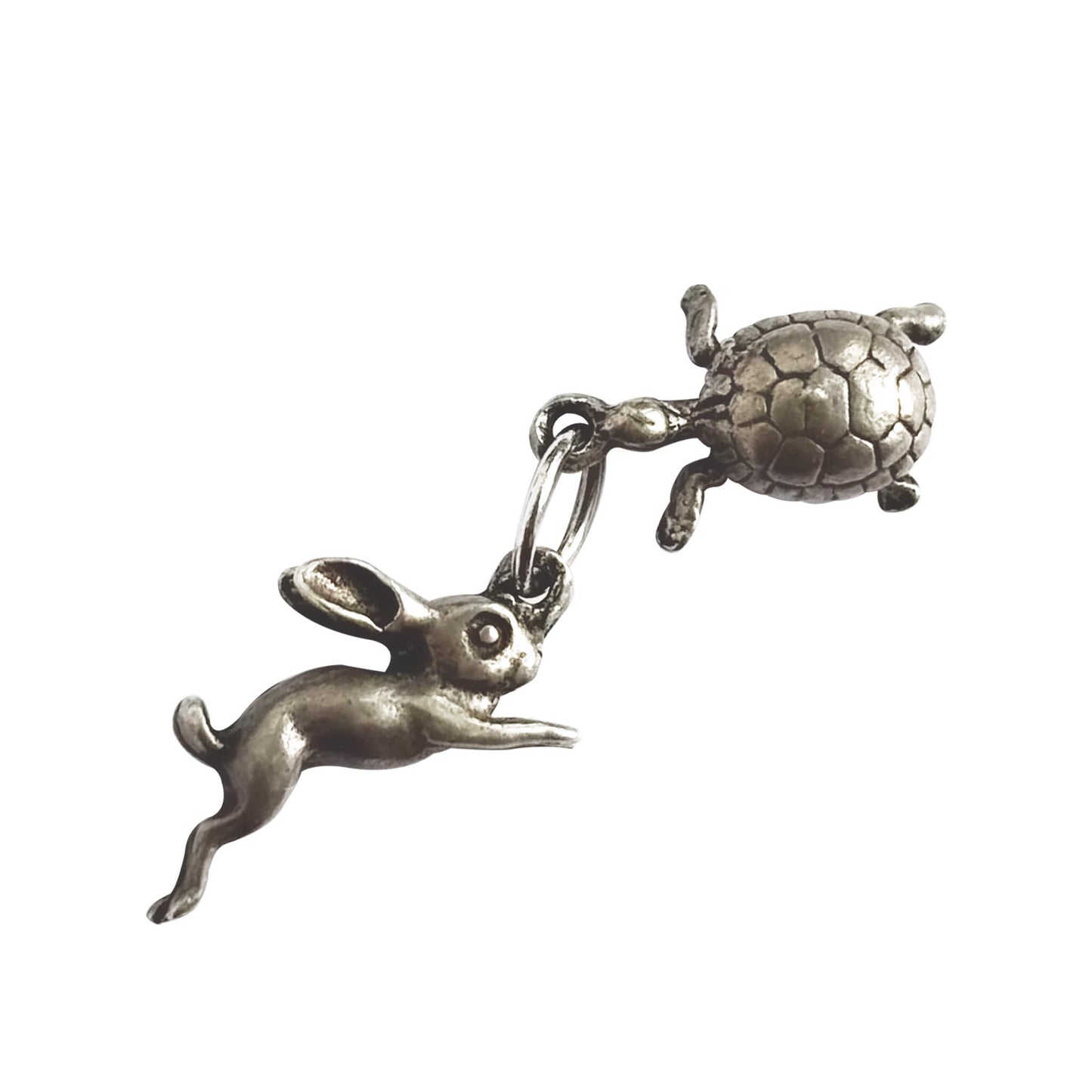 A vintage silver hare and tortoise charm on a white background.