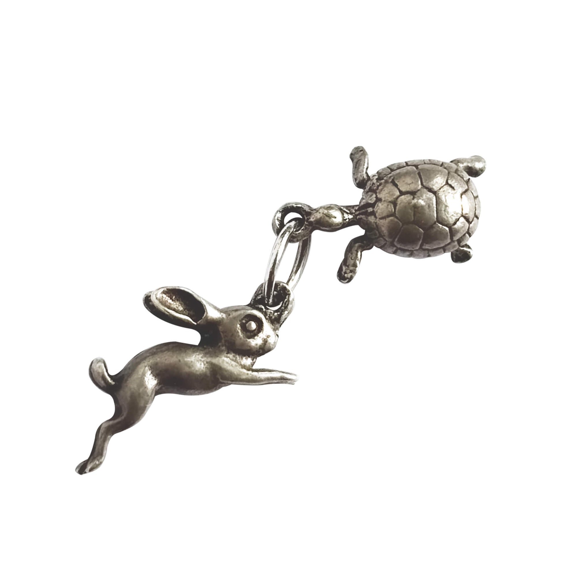 A vintage silver hare and tortoise charm on a white background.