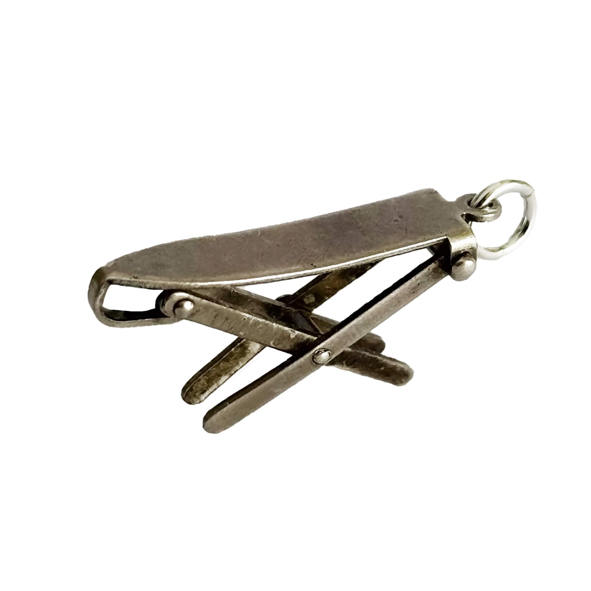 Silver ironing board charm on a white background