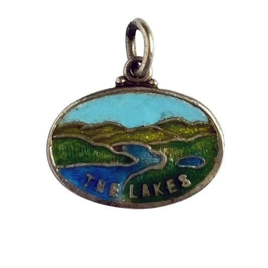 Vintage sterling silver and enamel oval Lake District charm on white background.