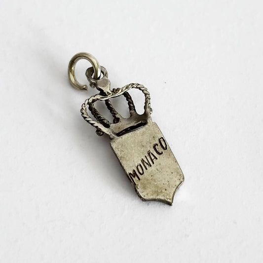 Silver and enamel Monaco flag and crown charm viewed from reverse on a white background