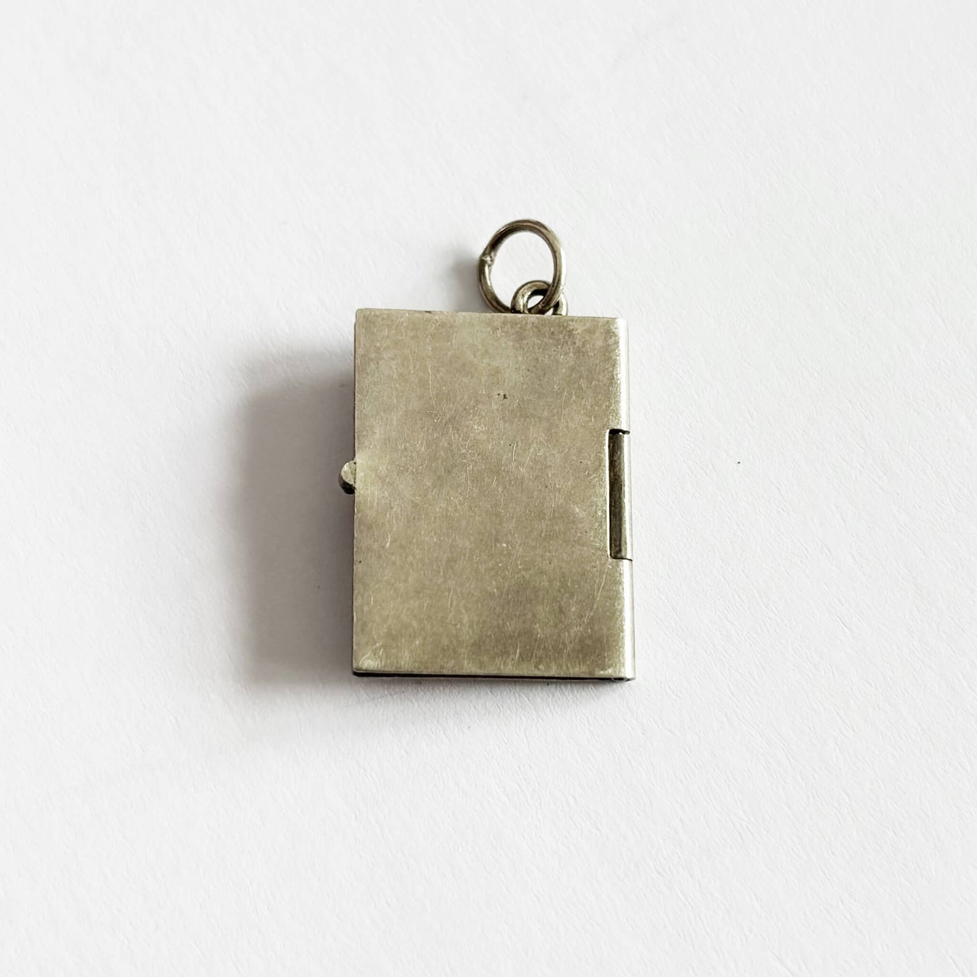 back of a passport pendant on a white background