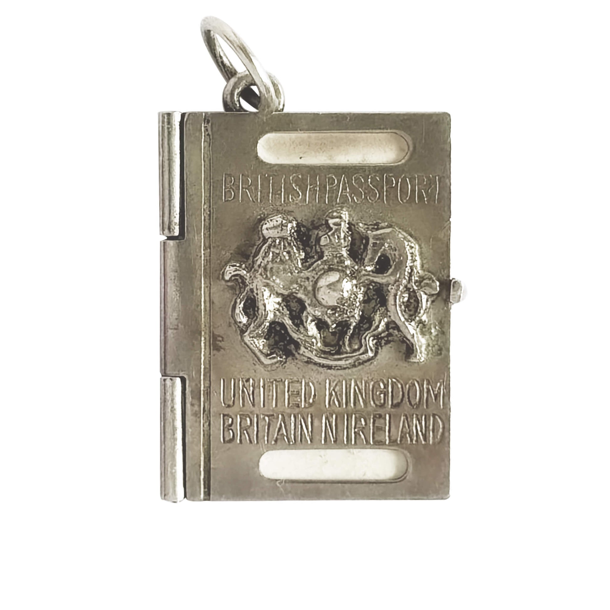 Silver charm resembling a British passport with a coat of arms on a white background