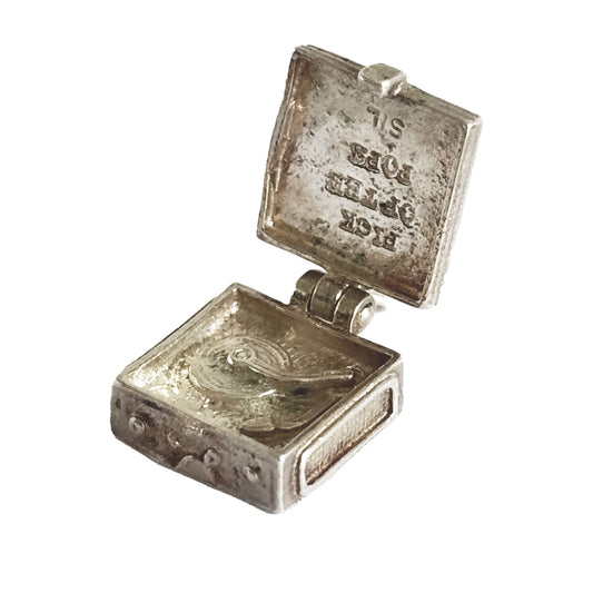 Vintage silver record player charm opening to record on turntable and the words 'PICK OF THE POPS' on a white background.