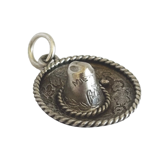 Silver sombrero-shaped pendant on a white background