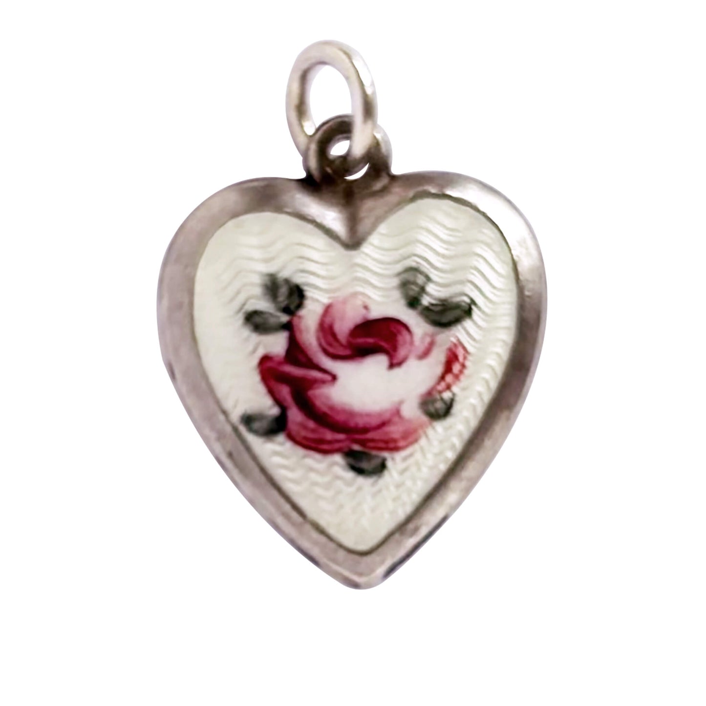 A vintage sterling silver heart charm with white guilloche enamel behind a pink rose