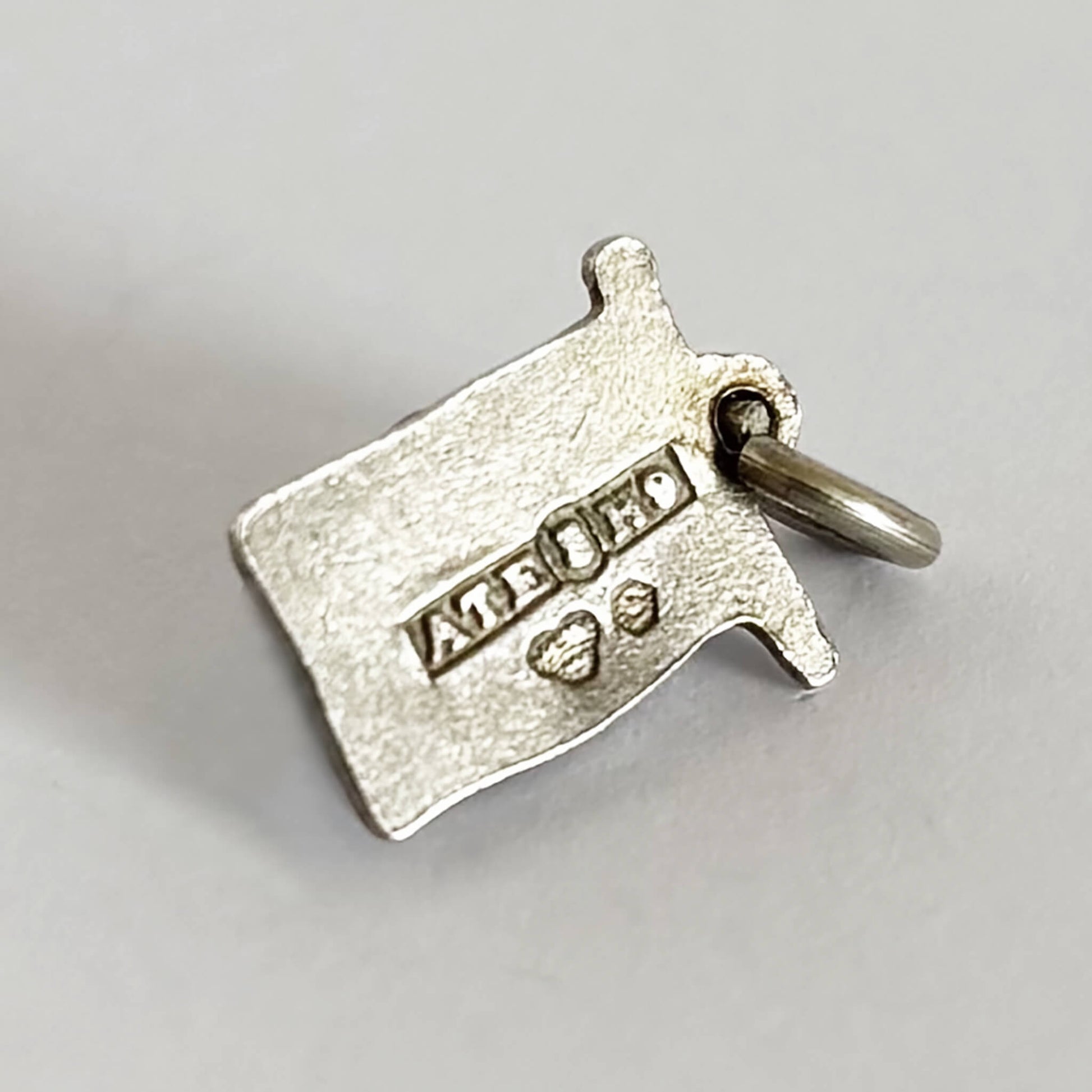 back of a flag of Sweden charm showing full 1958 hallmarks