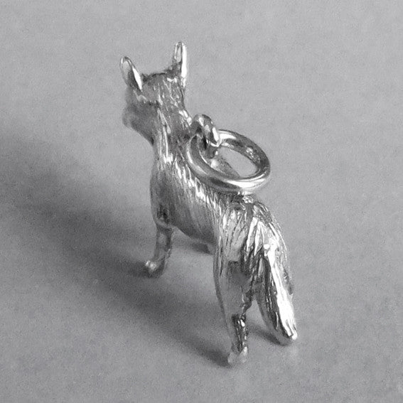Silver blue heeler dog charm seen from side on a grey background.