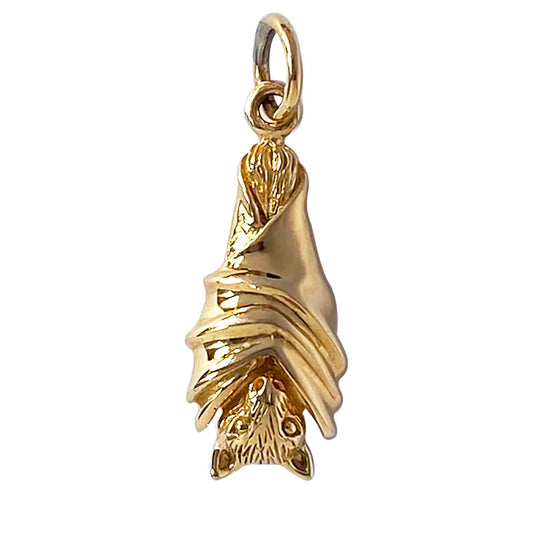 Bat charm in gold bronze hanging with wings folded