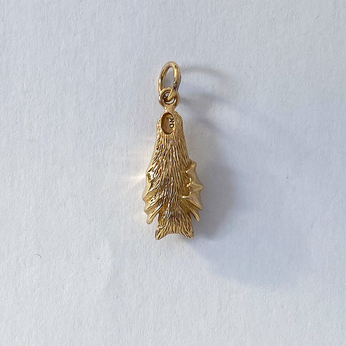 Bat charm in gold bronze hanging with wings folded pendant