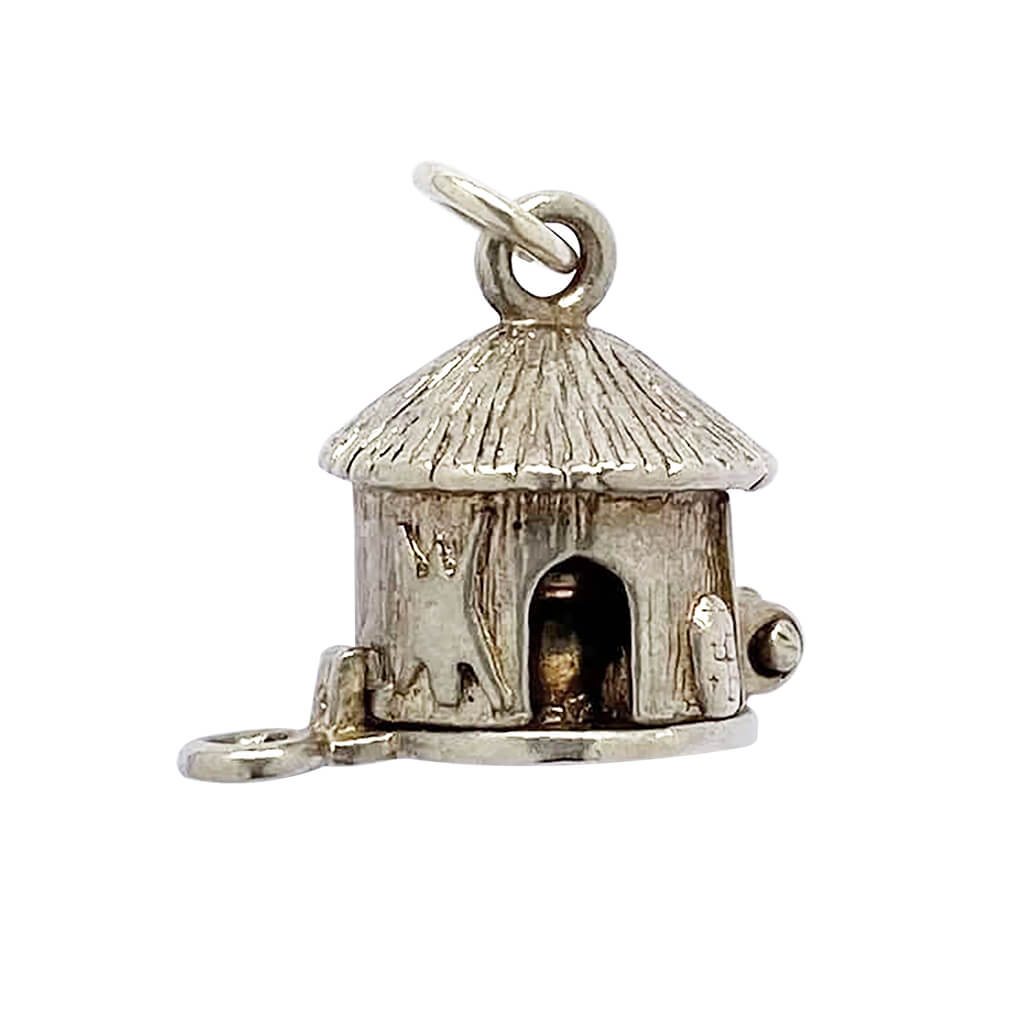 Mud hut opening to man in cauldron silver charm cannibal pendant