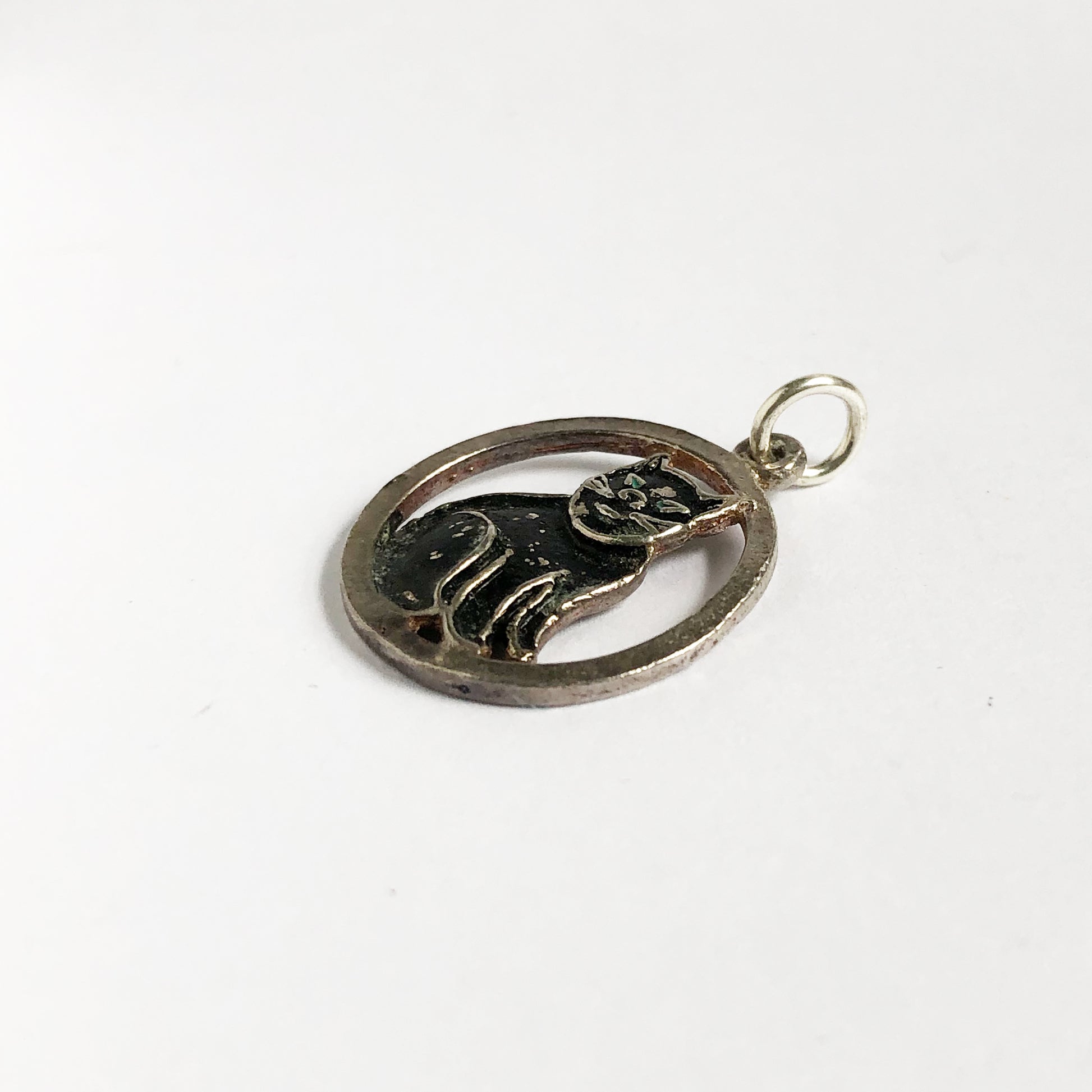 Vintage silver and black enamel cat charm with green eyes