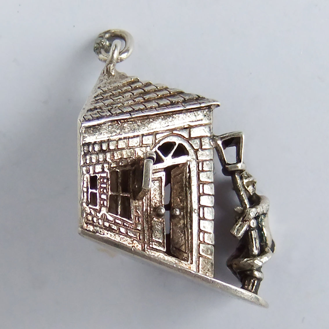 Vintage silver drunk person holding lamppost outside pub charm