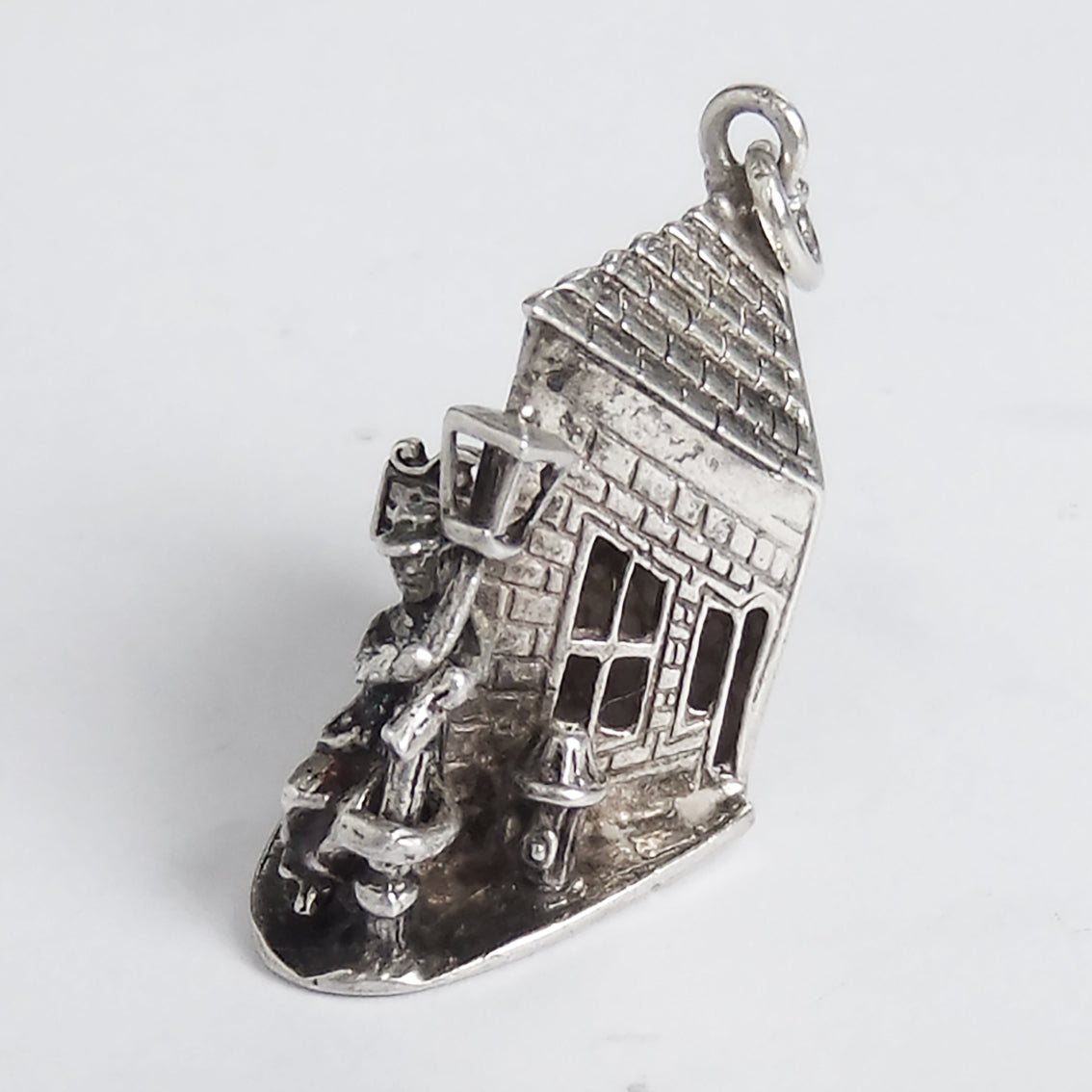 Vintage silver drunk person and bottle by lamppost outside pub charm