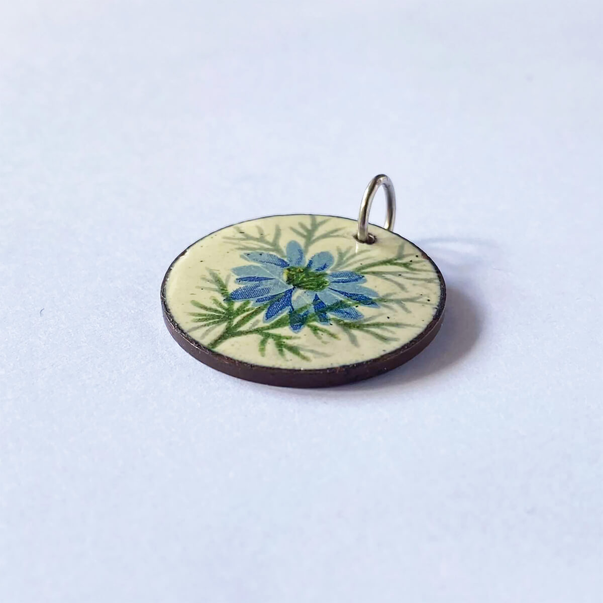 Vintage 1950s British coin charm Halfpenny Queen Elizabeth with enamel blue nigella flowers pendant from Charmarama