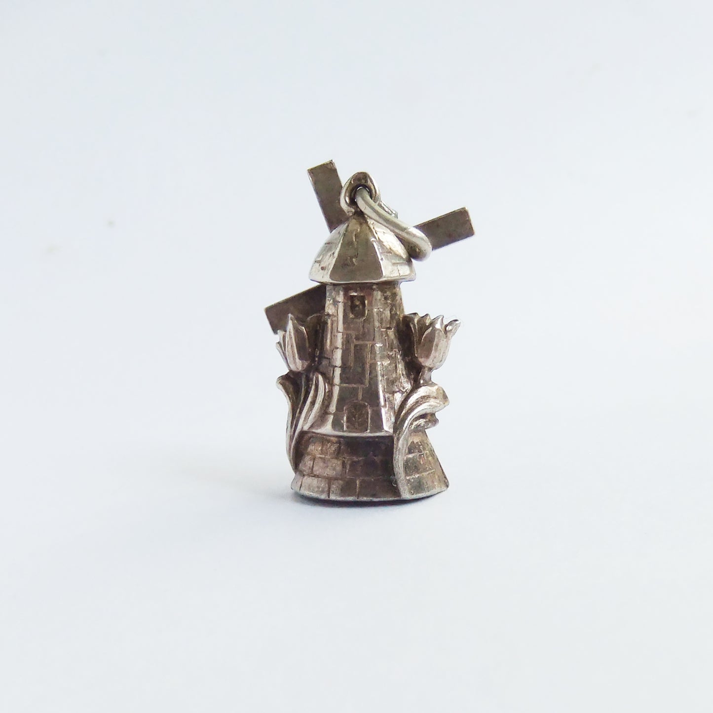 Vintage Dutch windmill charm with moving sails and tulip flowers