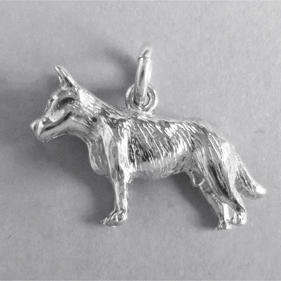 Silver blue heeler dog charm seen from side on a grey background.