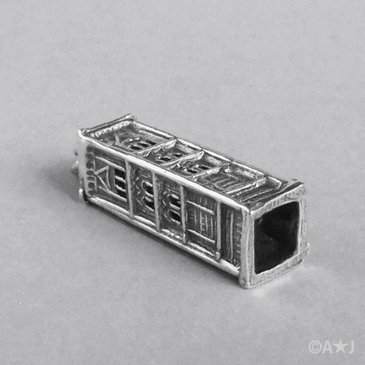 Sterling Silver Giotto’s Campanile Charm lying on a grey background