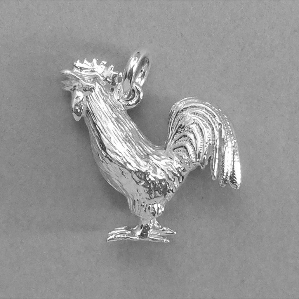 Sterling silver cockerel charm on grey background