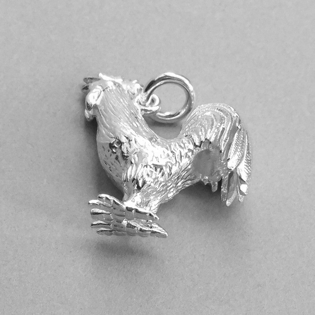 Sterling silver cockerel charm on white background
