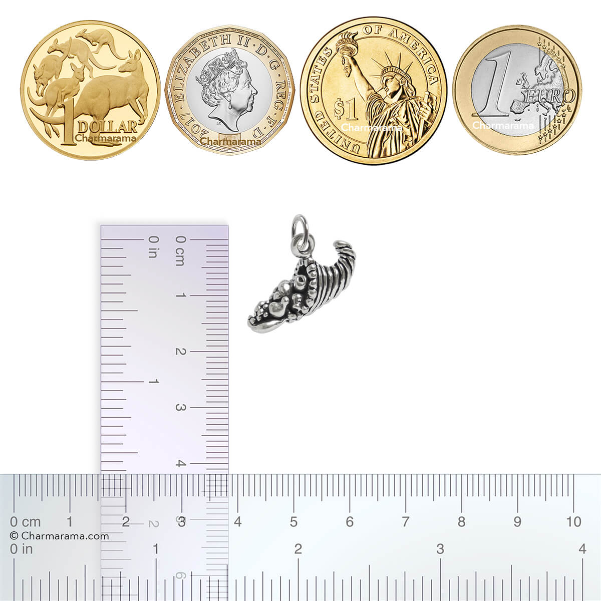 Sterling silver Cornucopia charm with coins and ruler for scale on a white background
