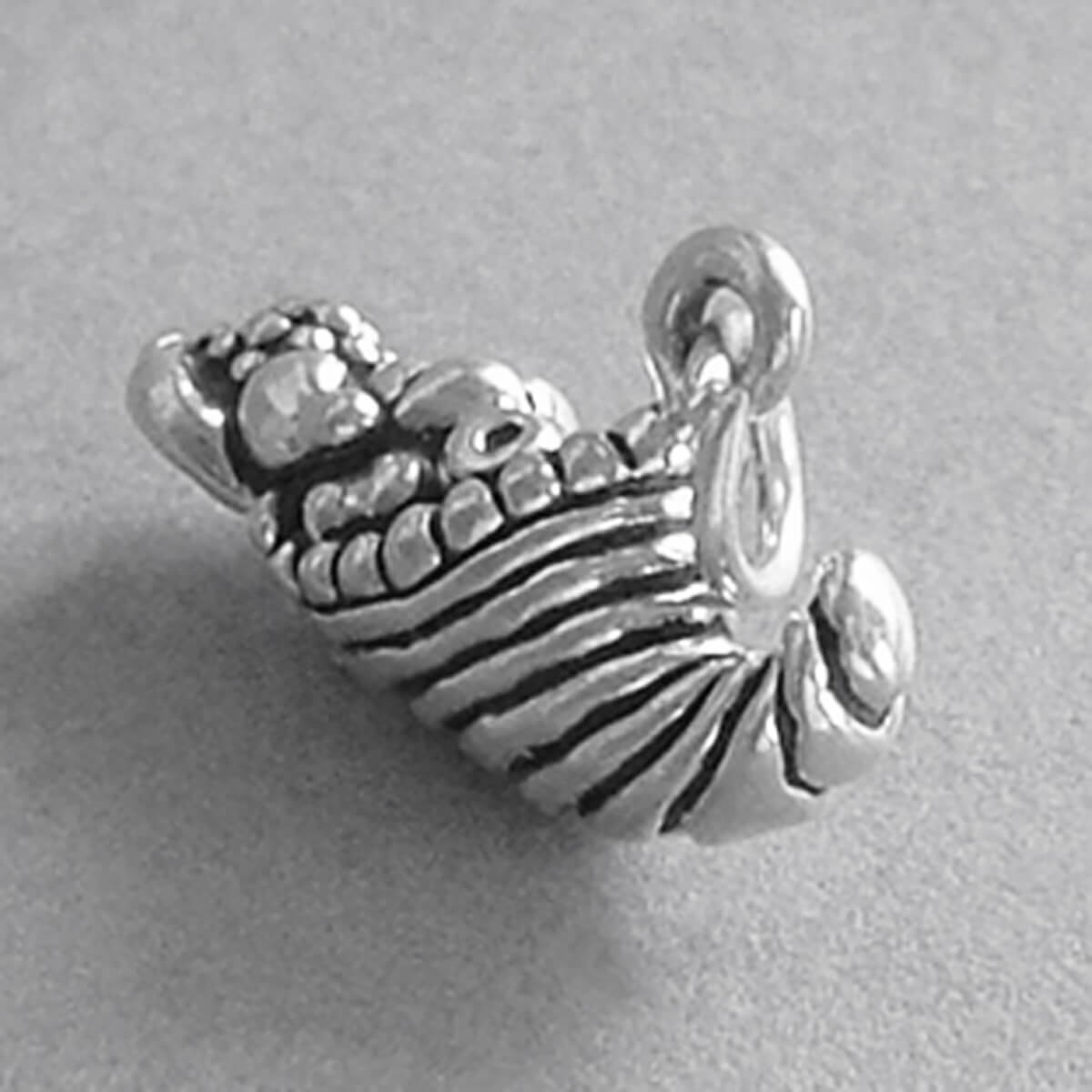 Sterling silver Cornucopia charm on a grey background