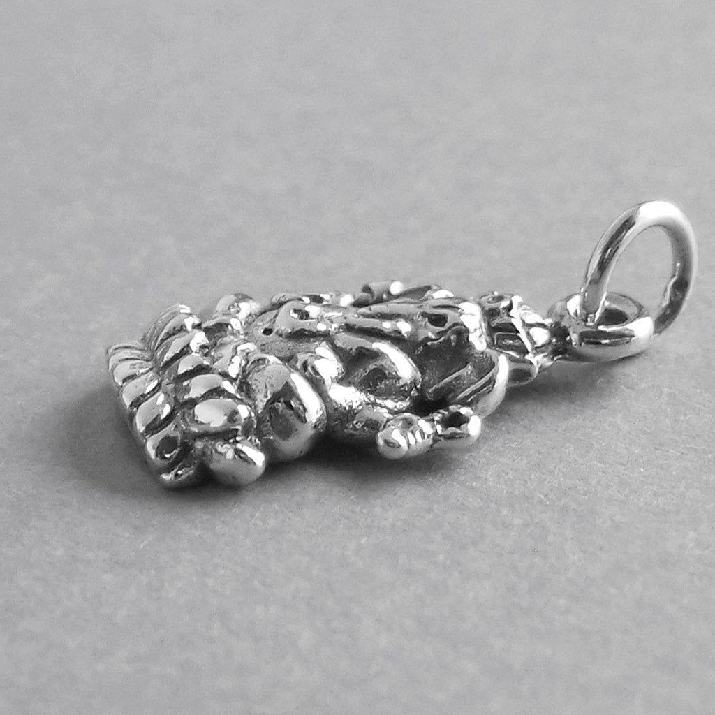 Sterling silver Ganesh charm on a grey background