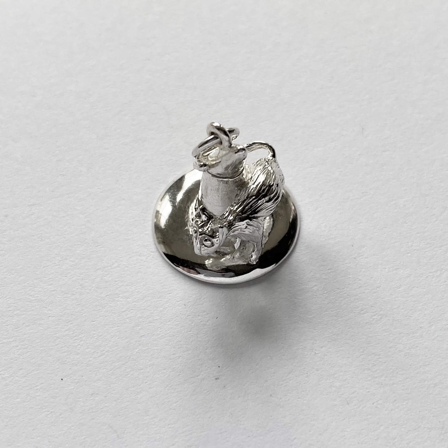 silver cat on witch hat charm on a white background