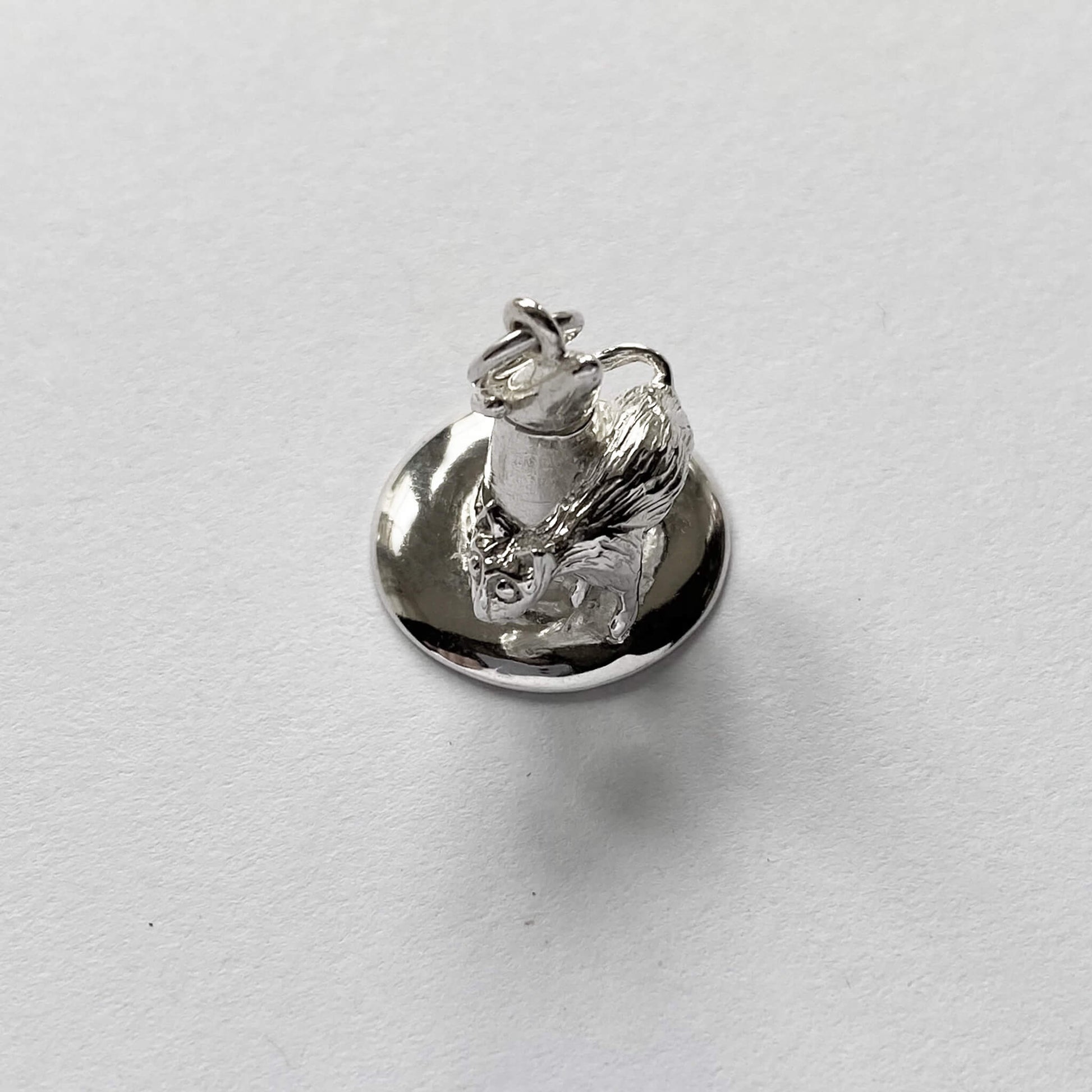 silver cat on witch hat charm on a white background