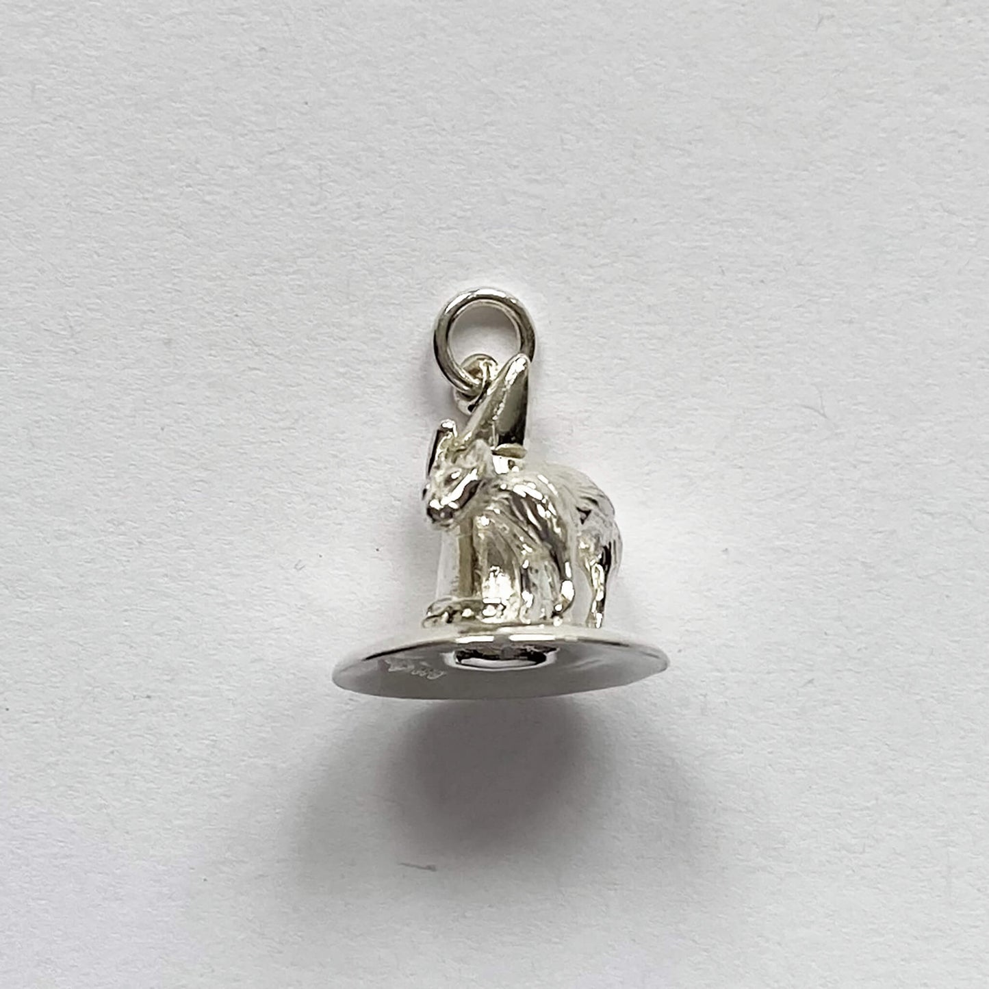 silver cat on witch hat charm on a grey background