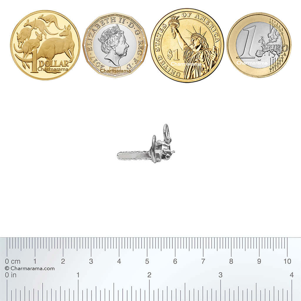 silver chainsaw charm with coins and ruler on a white background
