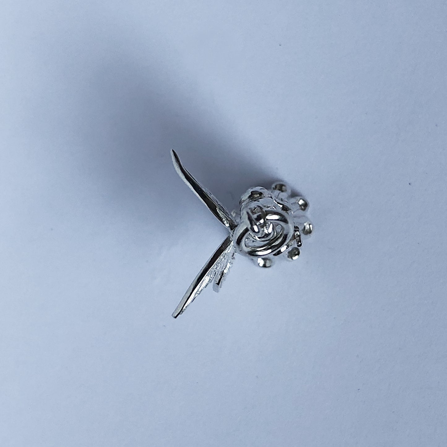 View from top of sterling silver Christmas tree fairy charm on a white background