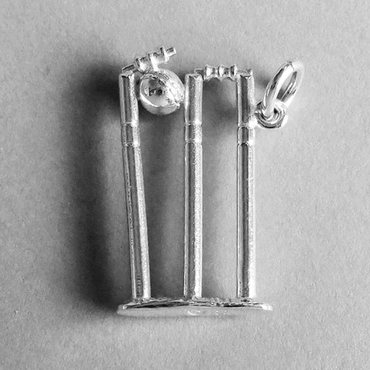 Sterling silver cricket stumps charm on a grey background