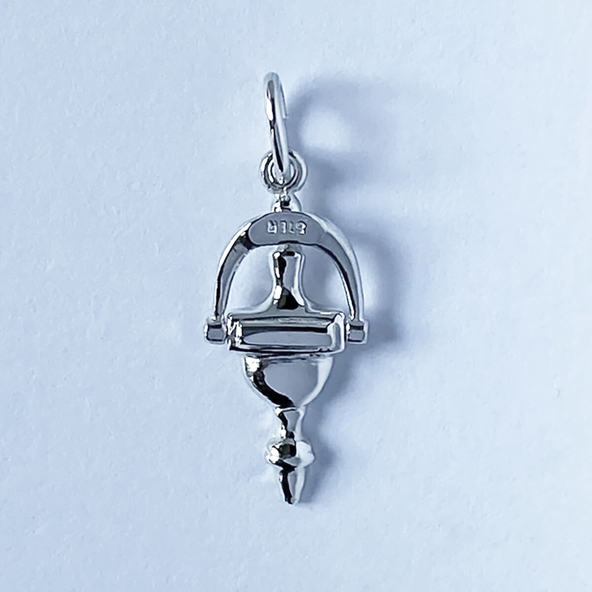 Sterling silver door knocker charm on a grey background