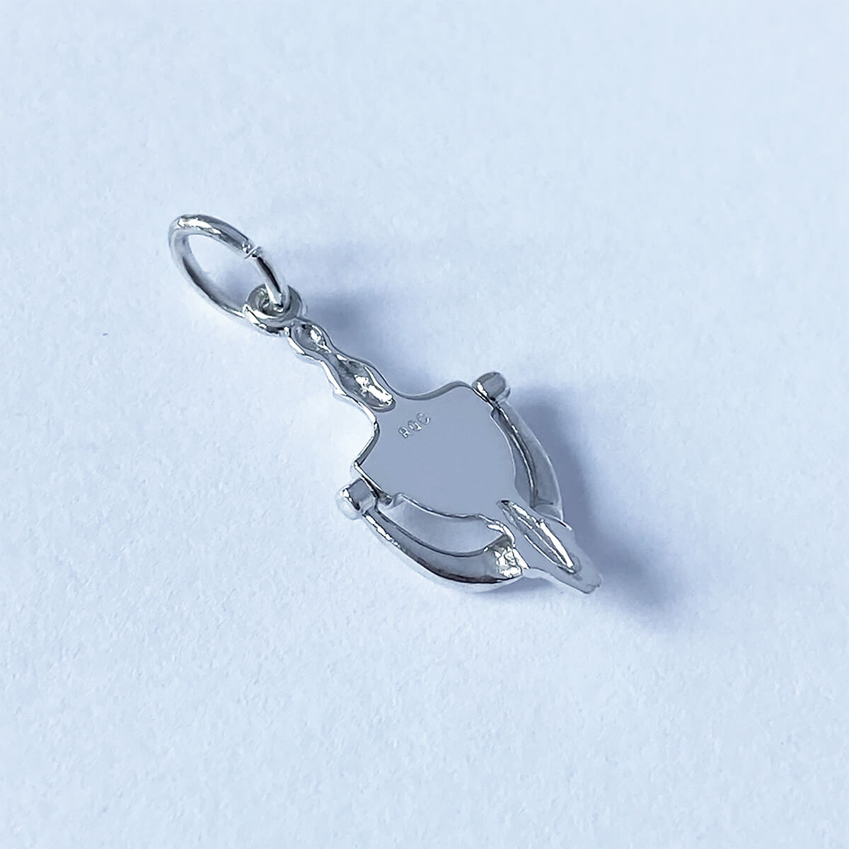 Back view of sterling silver door knocker charm on a white background