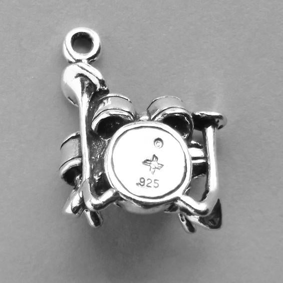Sterling silver drums charm on a grey background