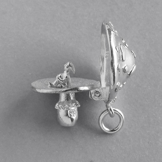 Sterling silver elf in toadstool charm on a white background
