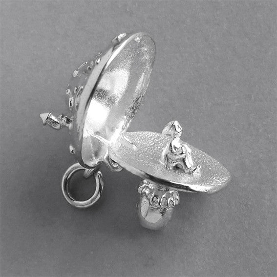 Sterling silver elf in toadstool charm on a grey background