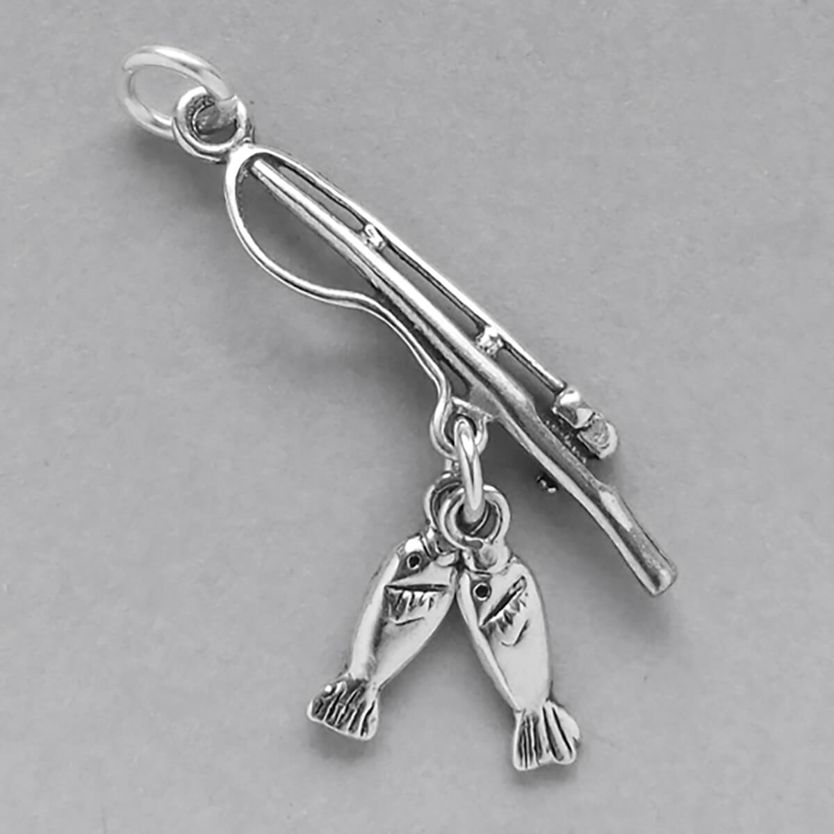 Sterling silver fishing pole and two fish charm on a grey background
