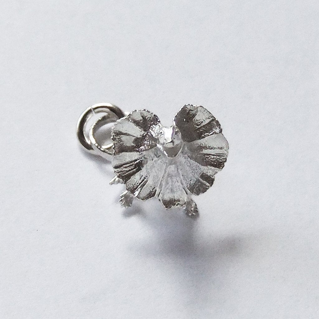 Sterling silver frill necked lizard charm on a white background