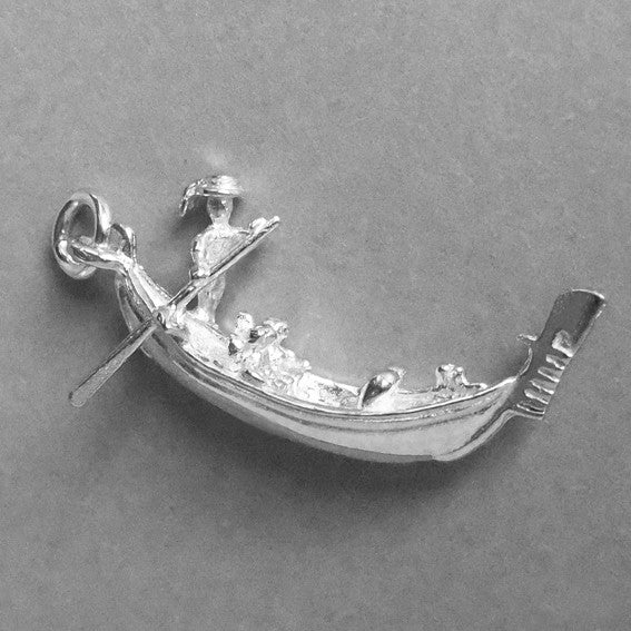 Sterling silver gondola charm on a grey background