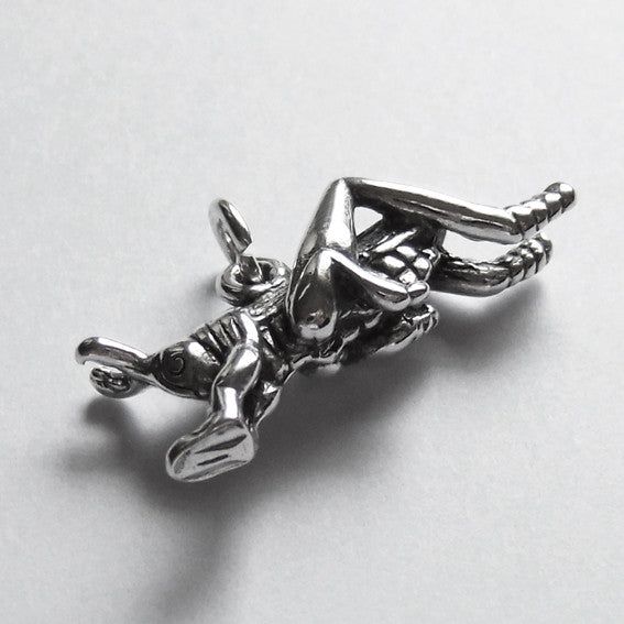 Sterling silver grasshopper charm on a grey background