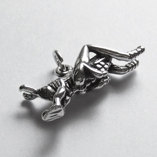Sterling silver grasshopper charm on a grey background