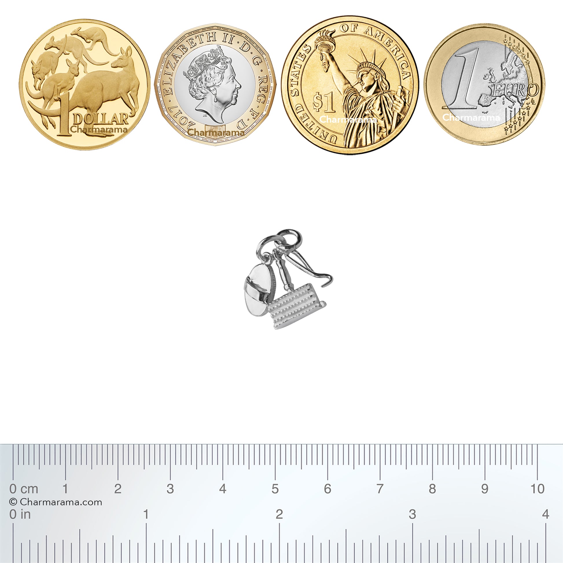 Sterling silver horse grooming brushes charm with coins and ruler for scale on a white background