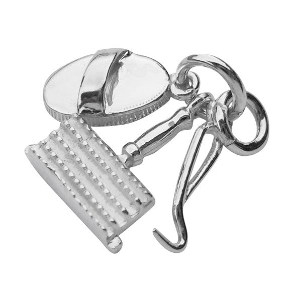 Sterling silver grooming kit charm on a white background