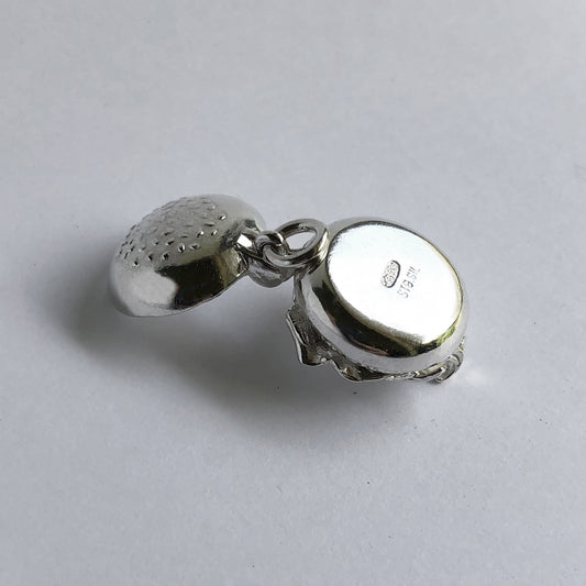 Sterling silver opened hamburger charm on a white background