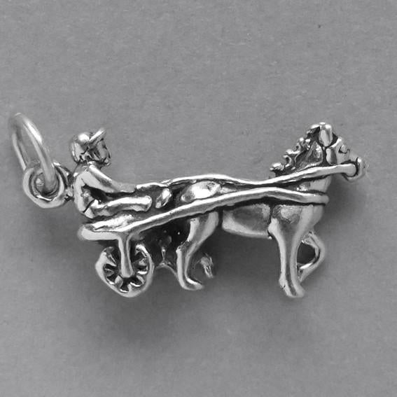 Sterling silver harness racer charm on a grey background