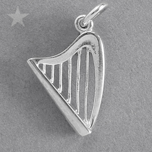 Sterling silver harp charm on a grey background