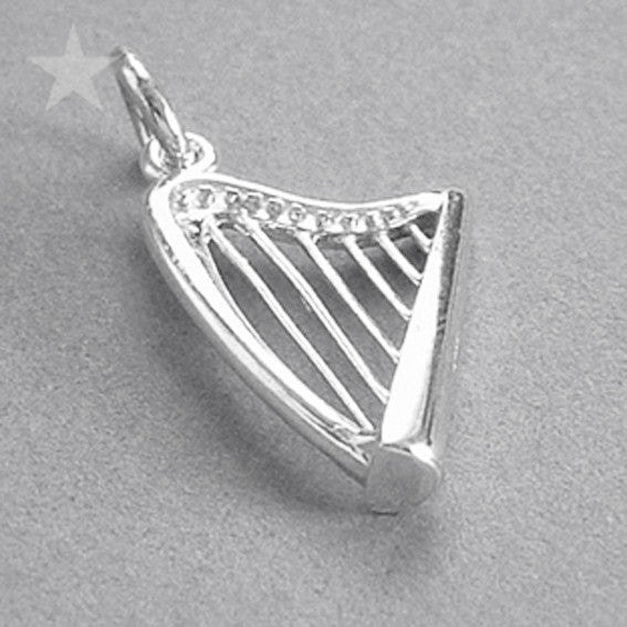 Sterling silver harp charm on a grey background