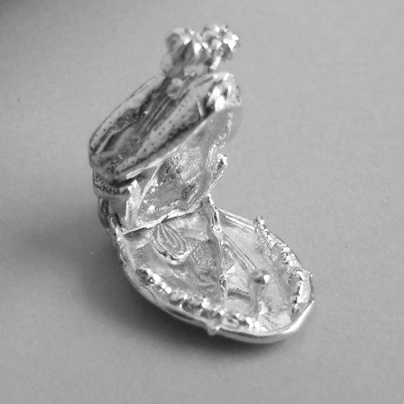 Sterling silver roast turkey charm open to onion and wishbone on a grey background